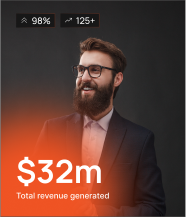 A bearded man in a suit and glasses stands smiling against a dark background. Overlaid text shows "$32m Total revenue generated," "98%" and "125+" at the top. An orange gradient highlights the lower part of the image.